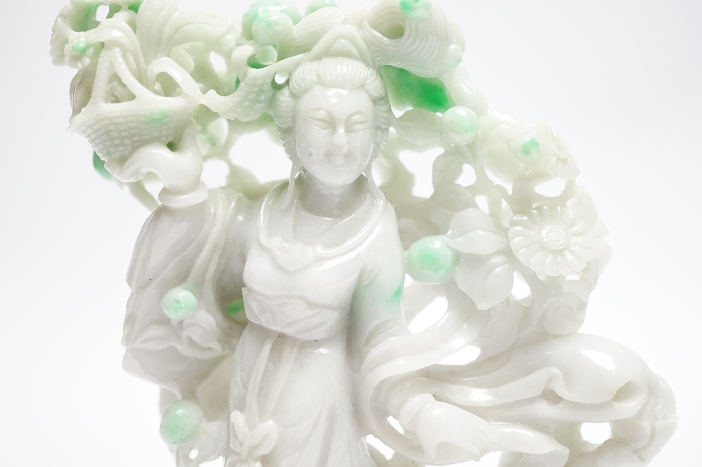 A Chinese jadeite figure of He Xiangu on carved stand, 17cm high